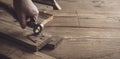 Carpenter removing rusty nails from old wooden planks
