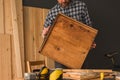 Carpenter repairing wooden drawer in woodwork workshop