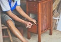 Carpenter repairing wooden drawers Three floors, small, new furniture, red wood, old Thai, polished, background color, people