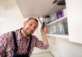Workman repair door on the cabinet in the kitchen Royalty Free Stock Photo