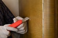 carpenter restoring wood cabinet,sealing a hole in furniture close-up