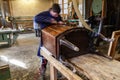 Carpenter restoring Wooden Furniture in his workshop