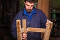 Carpenter restoring Wooden Stool Furniture in his workshop. Royalty Free Stock Photo