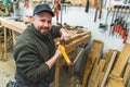 Carpenter with ruler and pencil taking measurements to cut a piece of wood Royalty Free Stock Photo