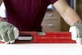 Carpenter`s hands checking level of wooden table at home. DIY projects, handyman Royalty Free Stock Photo