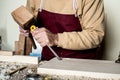 Carpenter`s hands with chisel on the woodworking bench