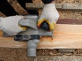 Carpenter`s hands with an electric planer in the workflow Royalty Free Stock Photo