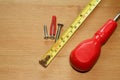 Carpenter\'s table with a tape measure, screws and a screwdriver Royalty Free Stock Photo