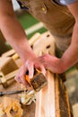 Carpenter with sanding block in carpentry