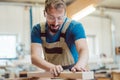 Carpenter sanding piece of wood by hand