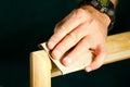 Carpenter man sanding wood molding for door frame Royalty Free Stock Photo