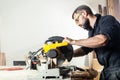 Carpenter sawing board with circular saw i Royalty Free Stock Photo