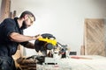 Carpenter sawing board with circular saw i Royalty Free Stock Photo