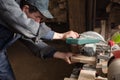 Carpenter sawing a board on a machine with a circulation saw Royalty Free Stock Photo