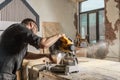 Carpenter saws a modern circular saw