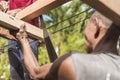 A carpenter saws off the excess edge of a wood rafter. Building or reconstructing a wooden roof frame for a rural home