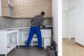 A carpenter sets up a working surface in the kitchen