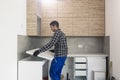 A carpenter sets up a working surface in the kitchen