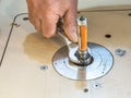 Carpenter setting CNC milling machine with a wrench