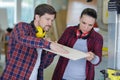 carpenter showing apprentice how to use sawing machine Royalty Free Stock Photo