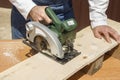 Carpenter slashes the board using an electric saw Royalty Free Stock Photo