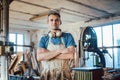 Carpenter standing in his wood workshop looking at camera Royalty Free Stock Photo