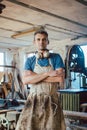 Carpenter standing in his wood workshop looking at camera Royalty Free Stock Photo