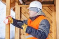 Carpenter with tablet PC near wooden building