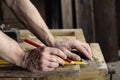 Carpenter taking measurement of a wooden plank Royalty Free Stock Photo