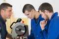 Carpenter teaching apprentices how to use circular saw