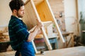 Carpenter testing wood plank evenness at workshop Royalty Free Stock Photo