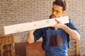 Carpenter testing wood plank evenness at workshop Royalty Free Stock Photo