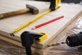 Carpenter tools and drill lie on wooden board Royalty Free Stock Photo