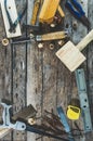 The carpenter tools on wooden bench, plane, chisel,mallet, tape measure, hammer, tongs, pliers, level, nails and a saw