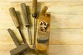 Carpenter tools on wooden table with sawdust. Craftperson workplace top view Royalty Free Stock Photo