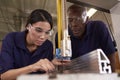 Carpenter Training Female Apprentice To Use Mechanized Saw