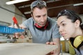 carpenter training female apprentice in workshop Royalty Free Stock Photo