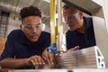 Carpenter Training Male Apprentice To Use Mechanized Saw Royalty Free Stock Photo