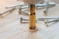 Carpenter use countersink bit to drill both a pilot hole and use countersink bit to recess the head of the screw into wood plank. Royalty Free Stock Photo