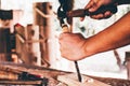 Carpenter use hammer and chisel woodworking furniture boxes in workshop Royalty Free Stock Photo