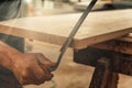 Carpenter uses manual cutting tool or drawknife