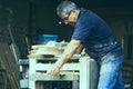 Carpenter using belt sander. Carpenter sanding a wood Royalty Free Stock Photo