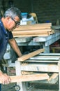 Carpenter using belt sander. Carpenter sanding a wood Royalty Free Stock Photo