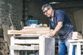 Carpenter using belt sander. Carpenter sanding a wood Royalty Free Stock Photo