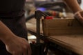 Carpenter using bench vise to hold timber block, starting furniture assembling Royalty Free Stock Photo