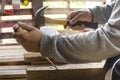 Carpenter using chisel and hammer in his hand with plank.Close up Royalty Free Stock Photo