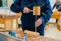 Carpenter using chisel and hammer to carve wood - close up Royalty Free Stock Photo