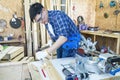 Carpenter using chisel and hammer. Young male carpenter working wood workshop Royalty Free Stock Photo