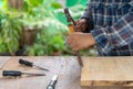 The carpenter using chisel to smooth  wood edge Royalty Free Stock Photo