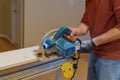 Carpenter using circular saw for cutting boards with hand power tools Royalty Free Stock Photo